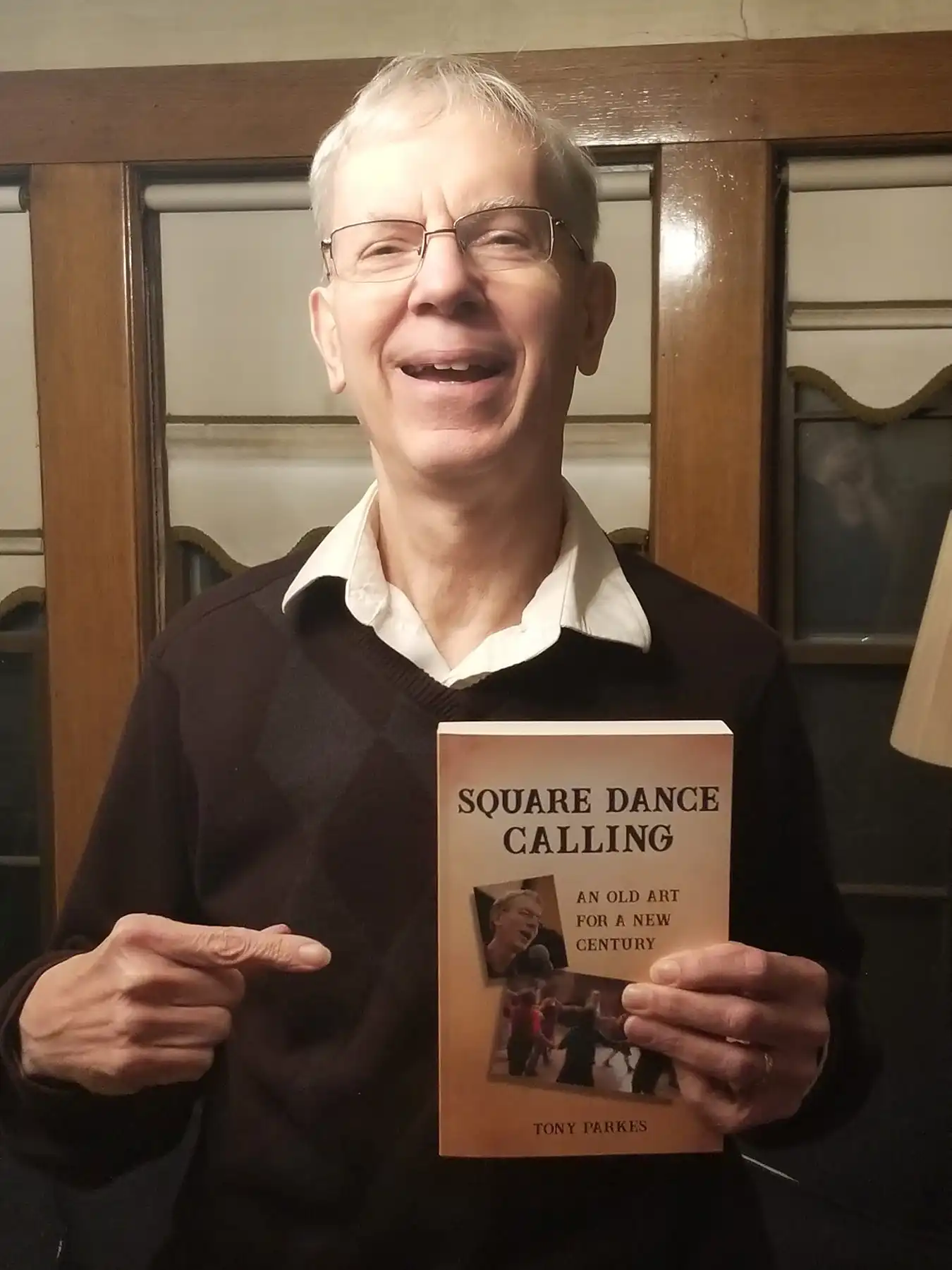 Tony Parkes with his book Square Dance Calling. Photo courtesy of David Millstone.