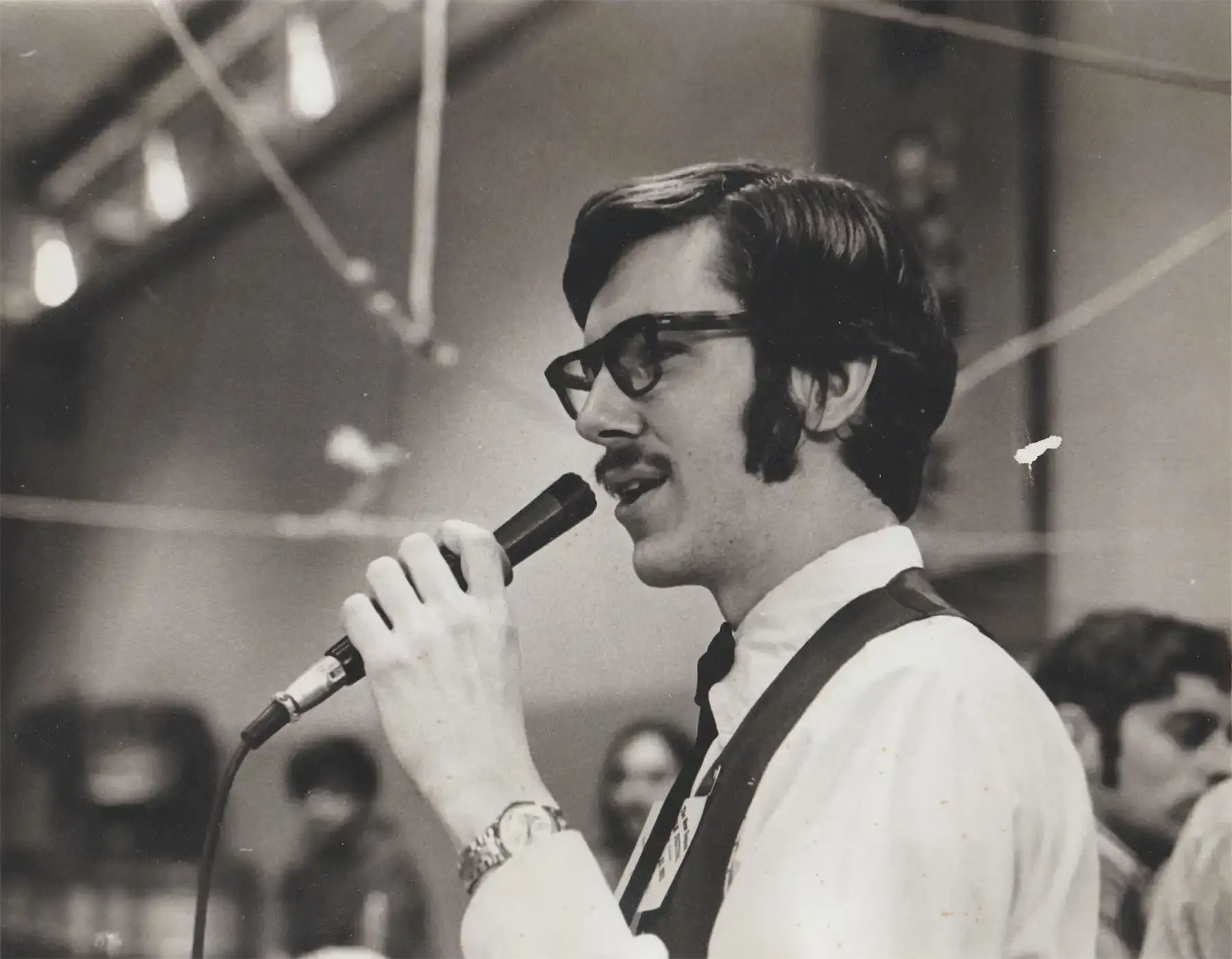 Tony Parkes at the mic in the 1980s. Photo courtesy of David Millstone.