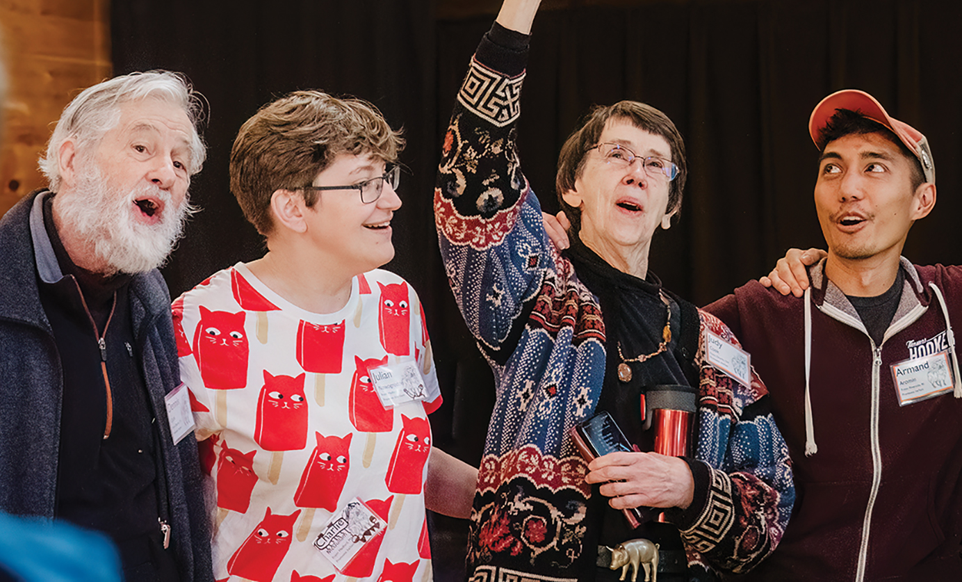 Four people singing.