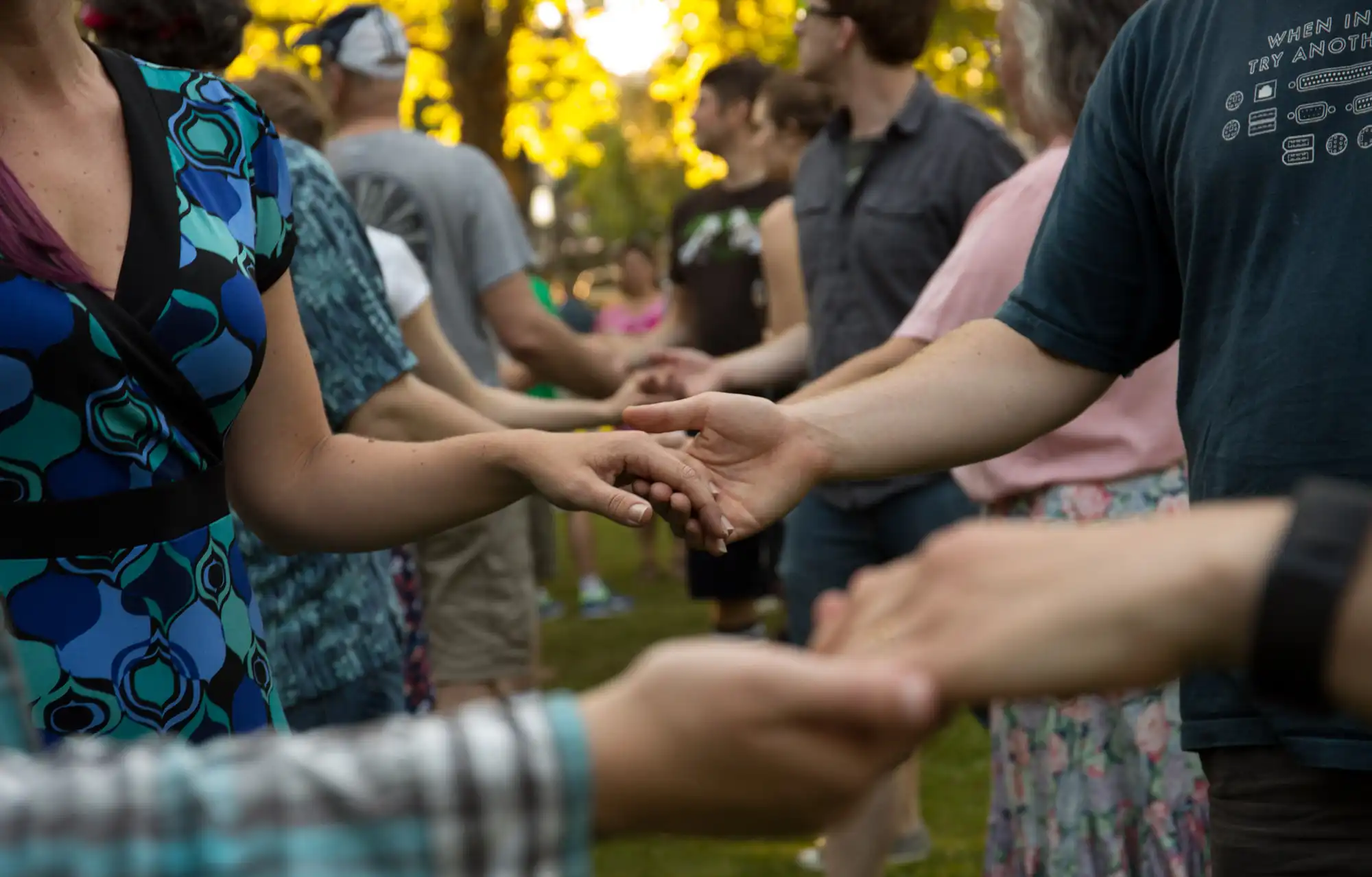 People holding hands in an outdoor dance