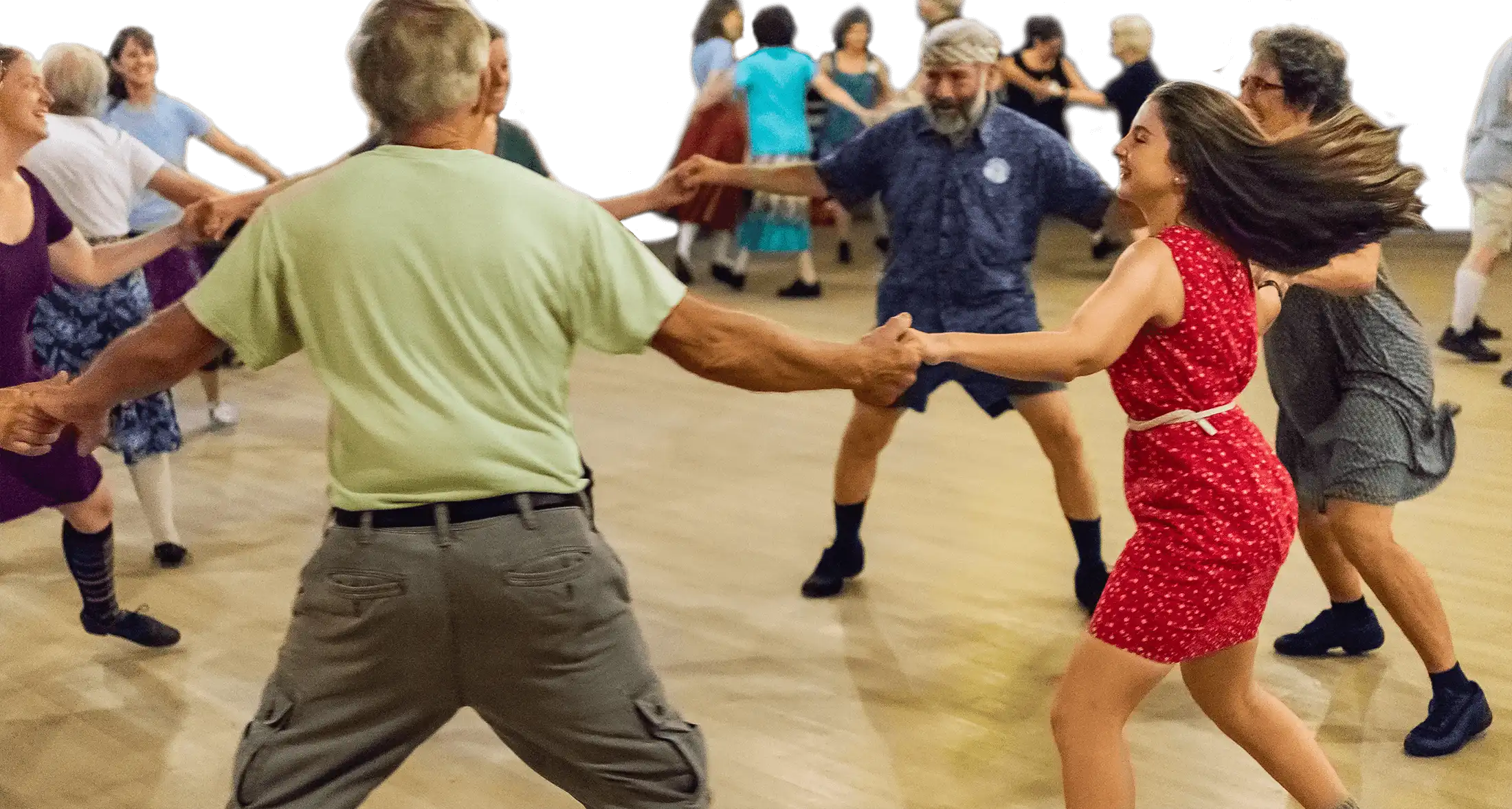 Smiling people hold hands in a circle dance