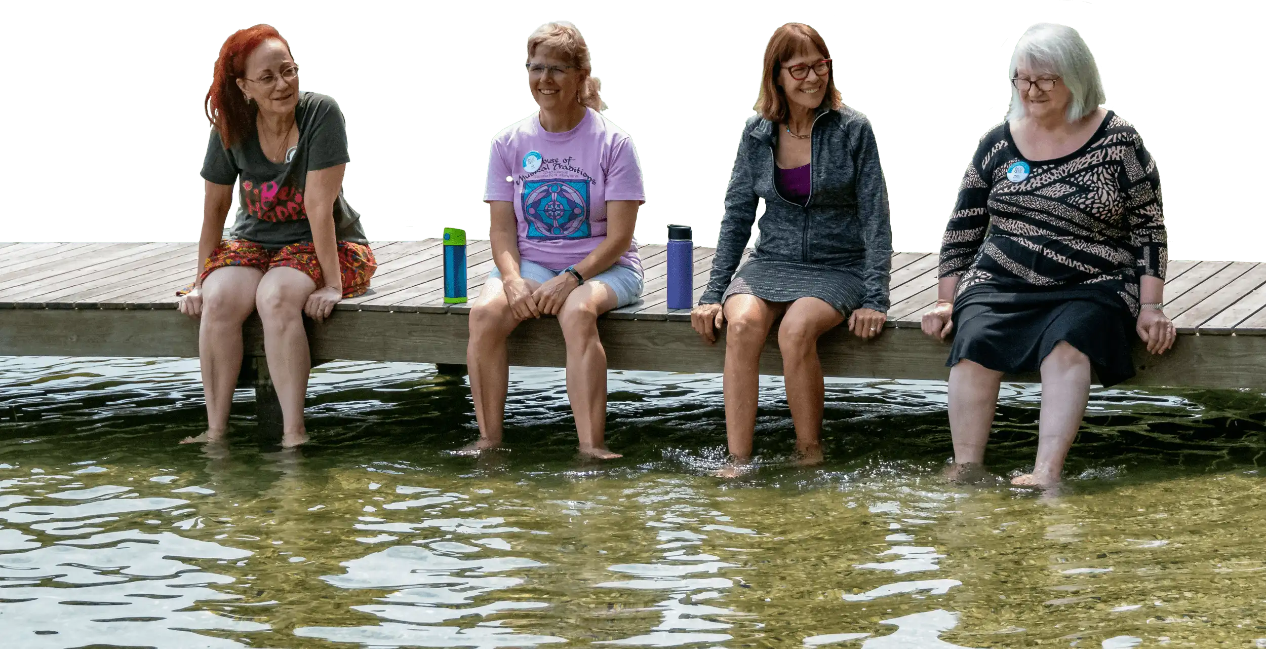 Campers sitting on a dock with their feet in the water