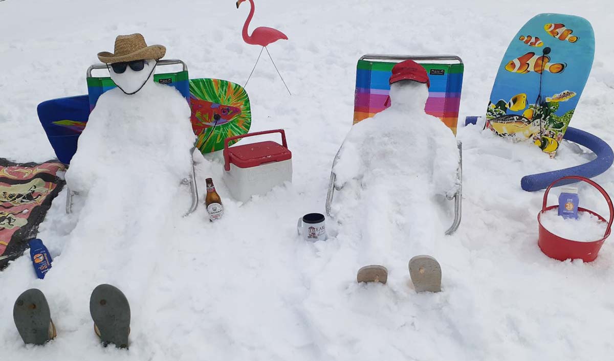 Snow people 'sunbathing' in beach chairs