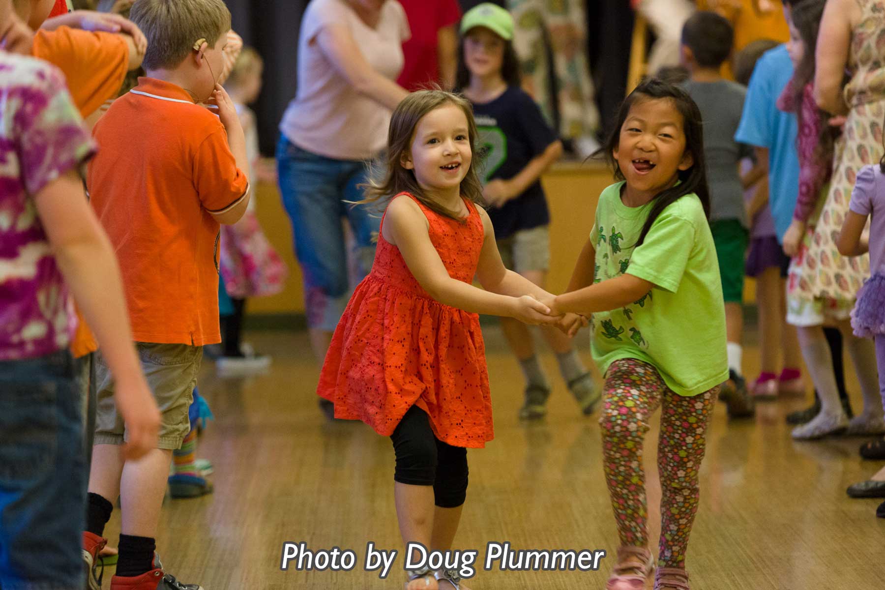 Young children holding hands in a dance