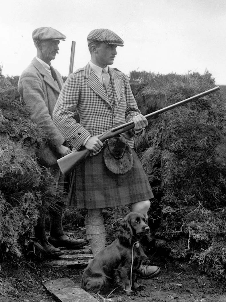 Gamekeepers with guns and a hunting dog