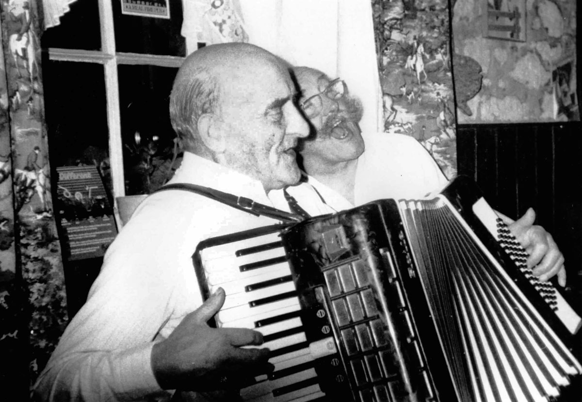 Flash Phelps playing accordion and Dick Corbett singing