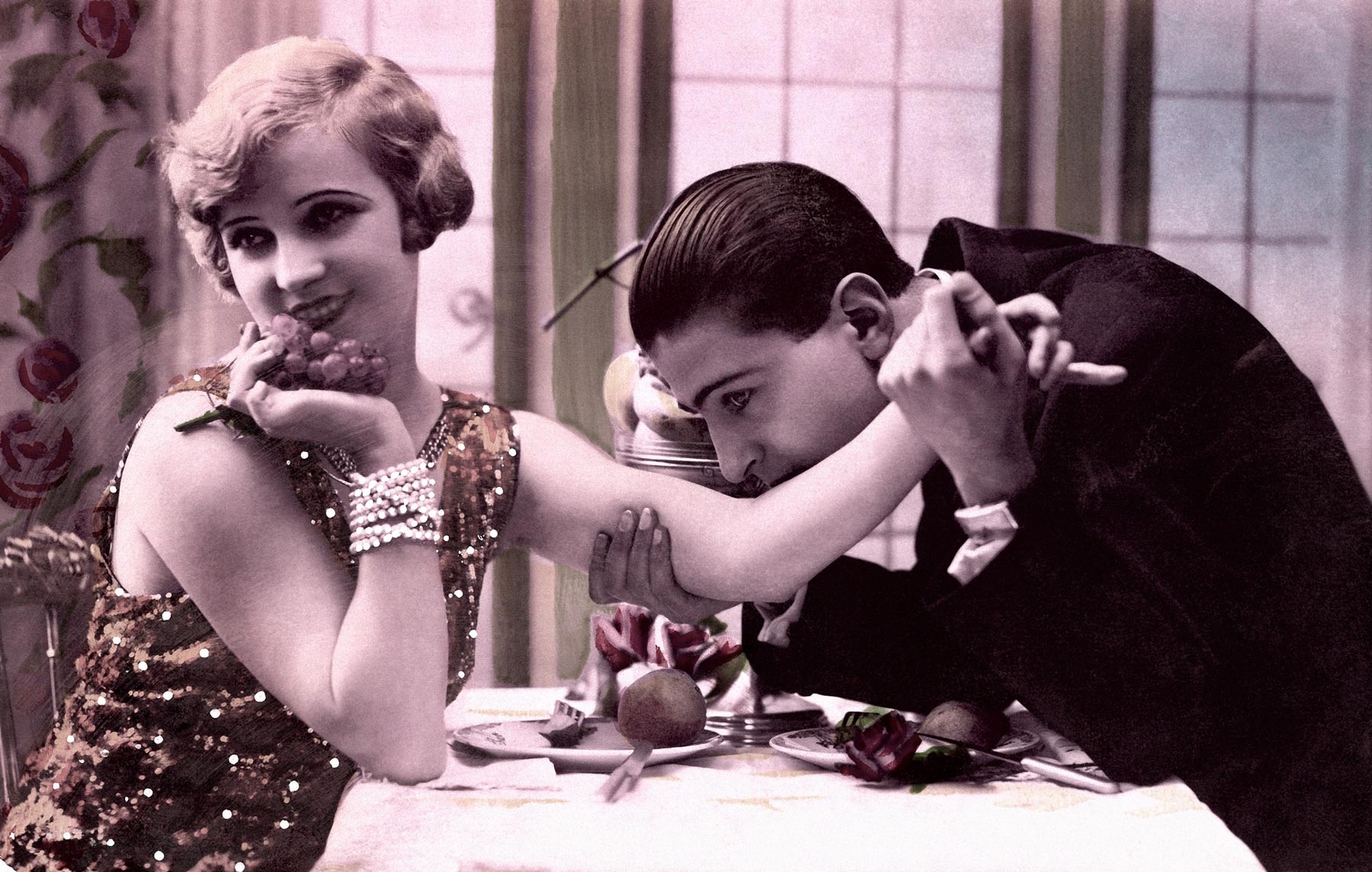 Actor Richard Barthelmess kisses the arm of a blushing Thelma Todd, in the 1928 movie "The Noose"
