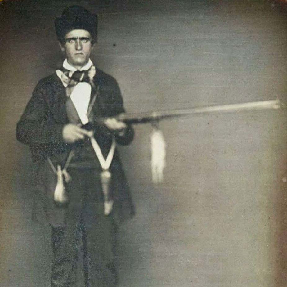 Daguerreotype photo of a young hunter with rifle and dog