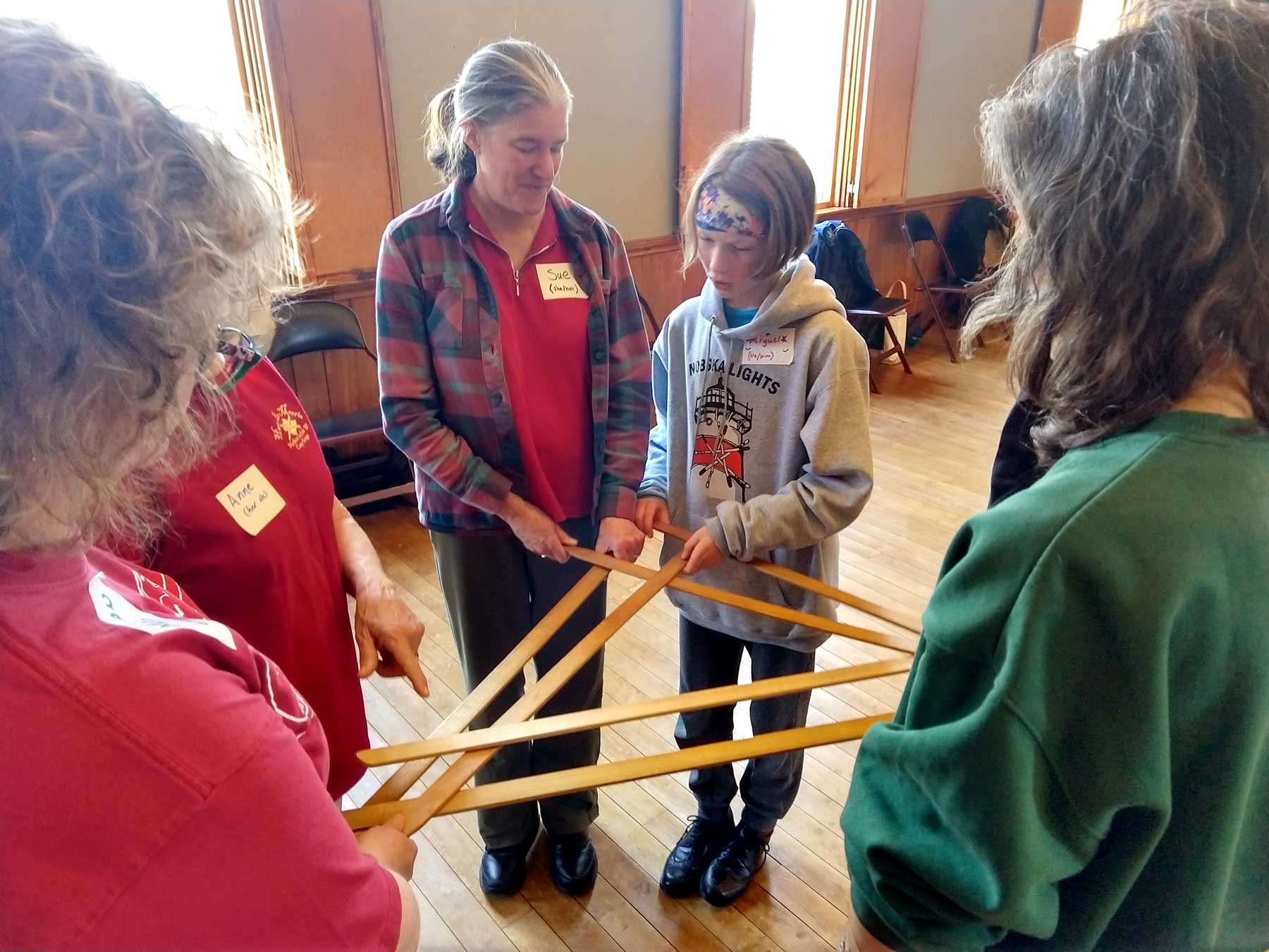 Participants creating a triangle-shaped sword lock