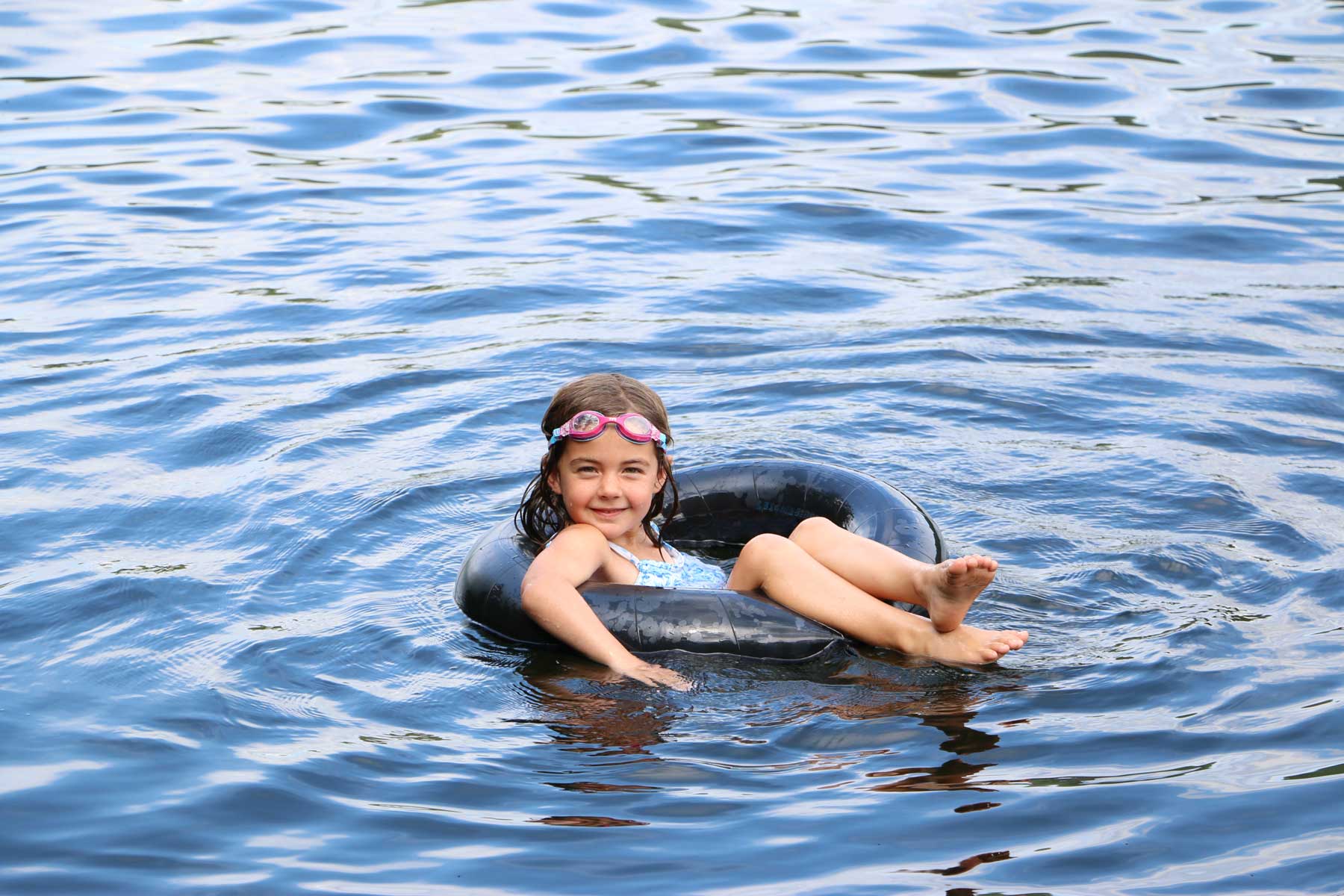 A young girl floats in an inner tube
