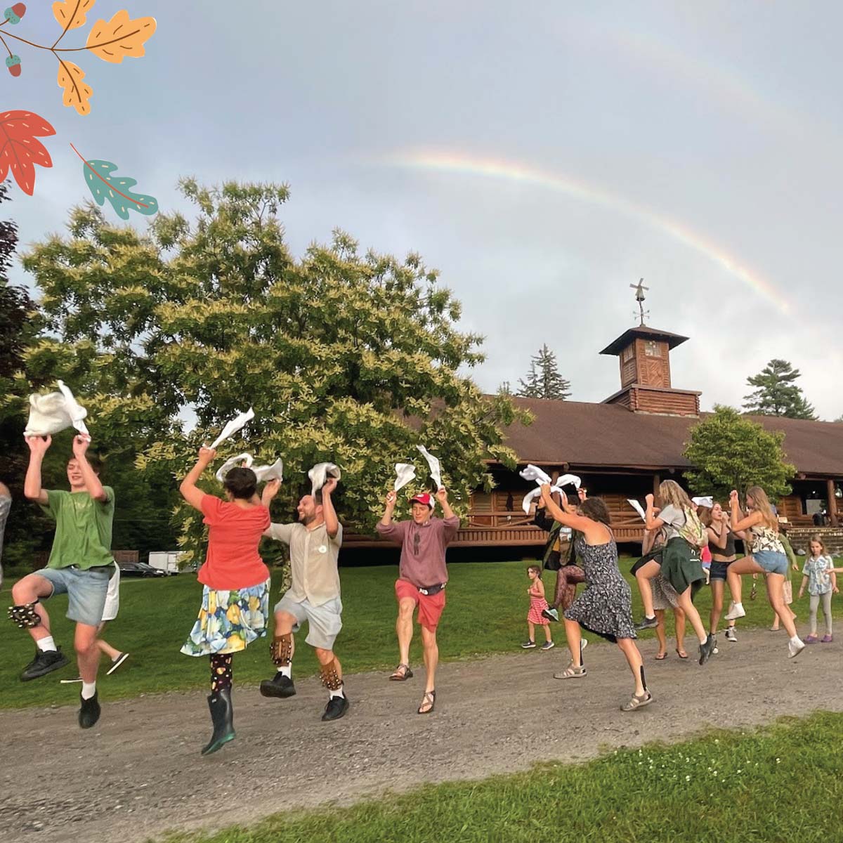 Dancers under a rainbow at CDSS's Family Week at Agassiz Village. Photo by Hamish Swanson.