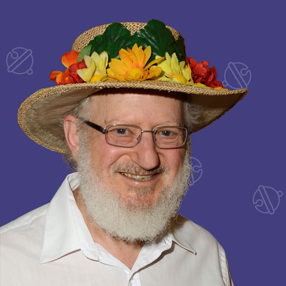 Ed Stern smiling in a flowered hat