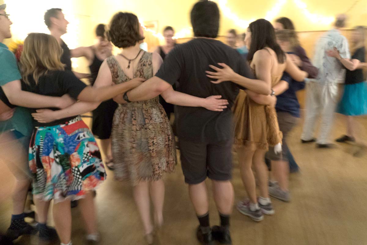 Younger dancers with arms around each other